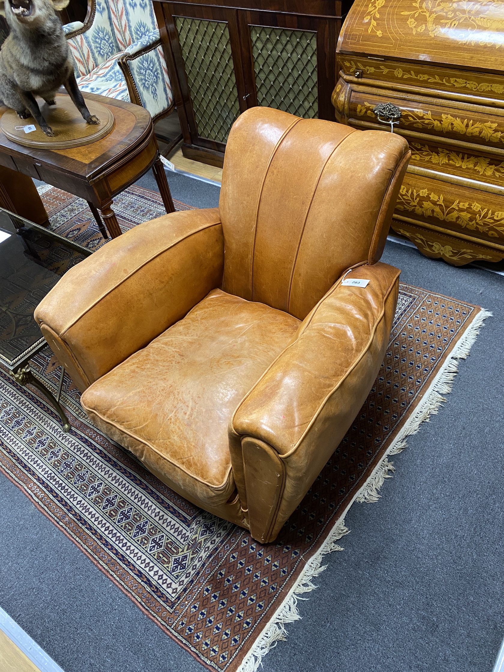 A pair of mid century tan leather club chairs, width 86cm, depth 90cm, height 78cm